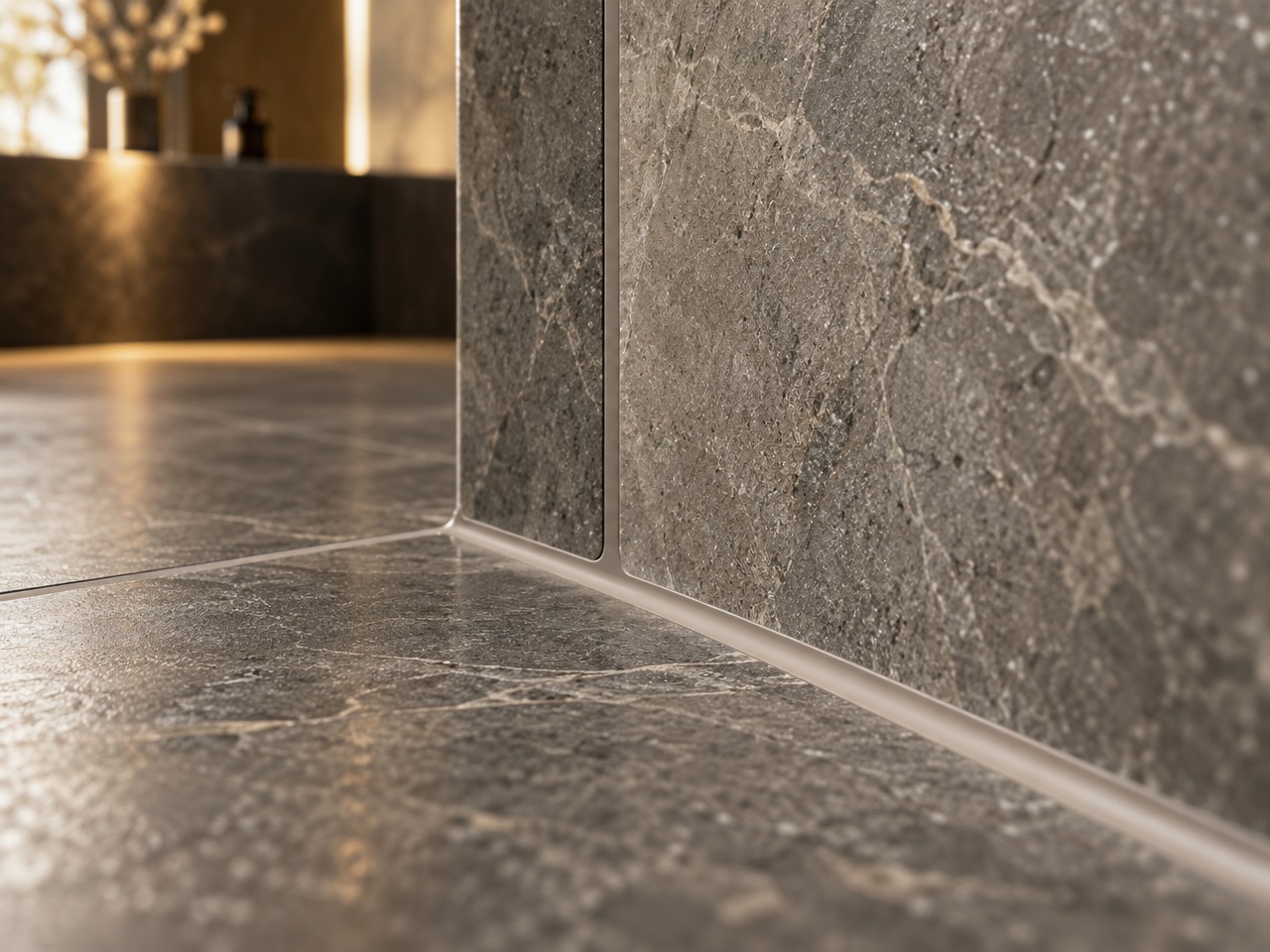 Illustrative image: precisely finished silicone joint between stone-look wall and floor tile